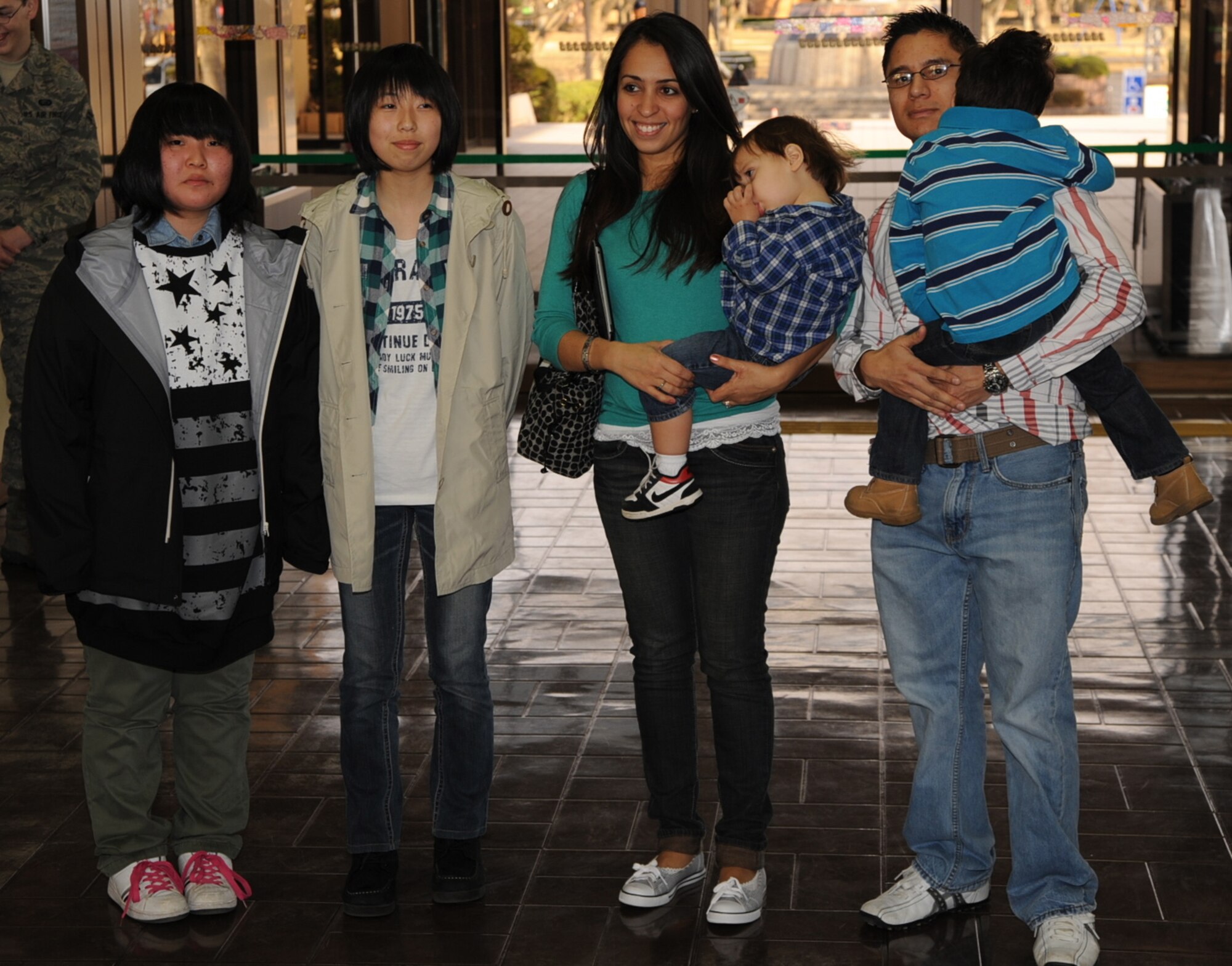 Hikaru Yasuda, left, and Hiyori Yamazaki, students from Taro Daiichi Junior High School, Miyako City, Japan, stand with the family of U.S. Air Force Staff Sgt. Luis Escobar, 35th Force Support Squadron, during a Homestay introduction ceremony at the Misawa City Civic Center, Misawa, Japan, March 29, 2013. Yasuda and Yamazaki come from the area where U.S. has supported recovery and rebuilding operations following the earthquake and tsunami disasters in 2011. Homestay operations were sponsored by the Misawa International Club. (U.S. Air Force photo by Senior Airman Derek VanHorn)