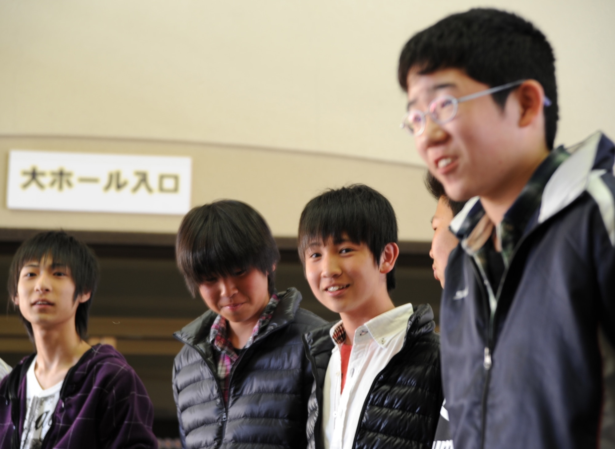 Japanese students from Taro Daiichi Junior High School, Miyako City, Japan,  smile as Tomoya Yamamoto, far right, introduces himself to Air Force families during a Homestay introduction ceremony at the Misawa City Civic Center, Misawa, Japan, March 29, 2013. Eleven students spent the weekend with six Air Force families at Misawa Air Base to share each other’s culture and strengthen the relationship between U.S. military and the community struck by a devastating earthquake and tsunami in 2011 that sparked Operation Tomodachi.  (U.S. Air Force photo by Senior Airman Derek VanHorn)