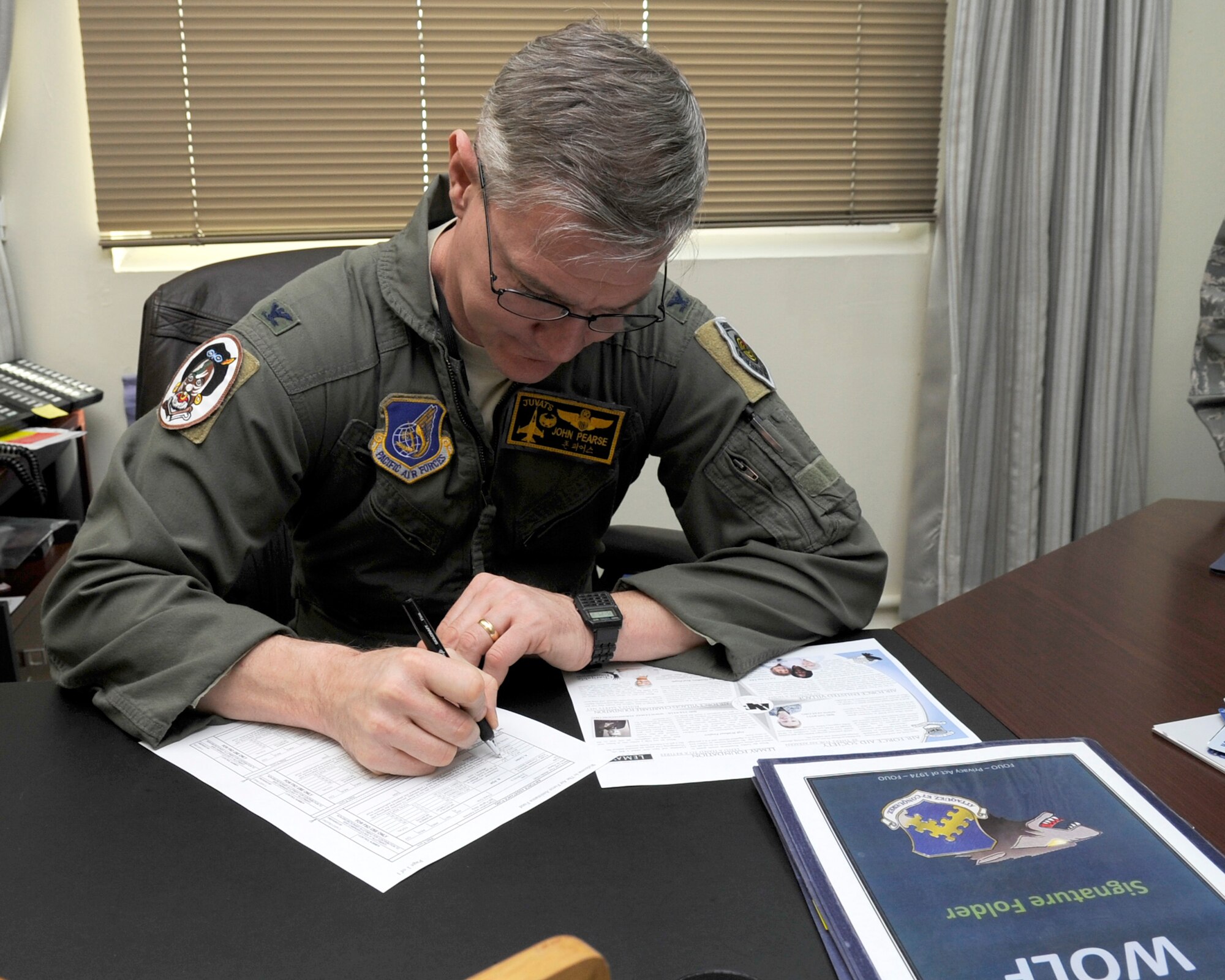 KUNSAN AIR BASE, Republic of Korea – Col. John Pearse, 8th Fighter Wing commander fills out an Air Force Assistance Fund campaign form to kick off the annual event at Kunsan Air Base, Republic of Korea, March 26, 2013. The AFAF consists of four organizations, the Air Force Villages Charitable Foundation, the Air Force Aid Society, the (General and Mrs. Curtis E.) LeMay Foundation, and the Air Force Enlisted Village. The campaign was established to provide an annual effort to raise funds for the charitable affiliates providing support to the Air Force family (active duty, retirees, reservists, guard and their dependents, including surviving spouses) in need. (U.S. Air Force photo by Staff Sgt. Tong Duong.)