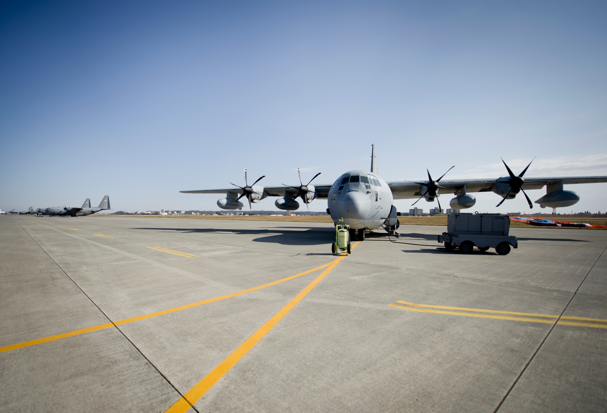 YOKOTA AIR BASE, Japan -- A Marine C-130 aircraft from Iwakuni, Japan, sits on the runway before takeoff March 26, 2013 at Yokota Air Base, Japan. Marine Aerial Refueler Transport Squadron 152th Training Squadron, 1st Marine Aircraft Wing, Iwakuni, Japan, worked alongside members from the 36th Airlift Squadron, doing controlled airspace training. Ultimately, the goal is to get an initial cadre qualified on the training so they can qualify the rest of their crews. (U.S. Air Force photo by Staff Sgt. Stacy Moless)