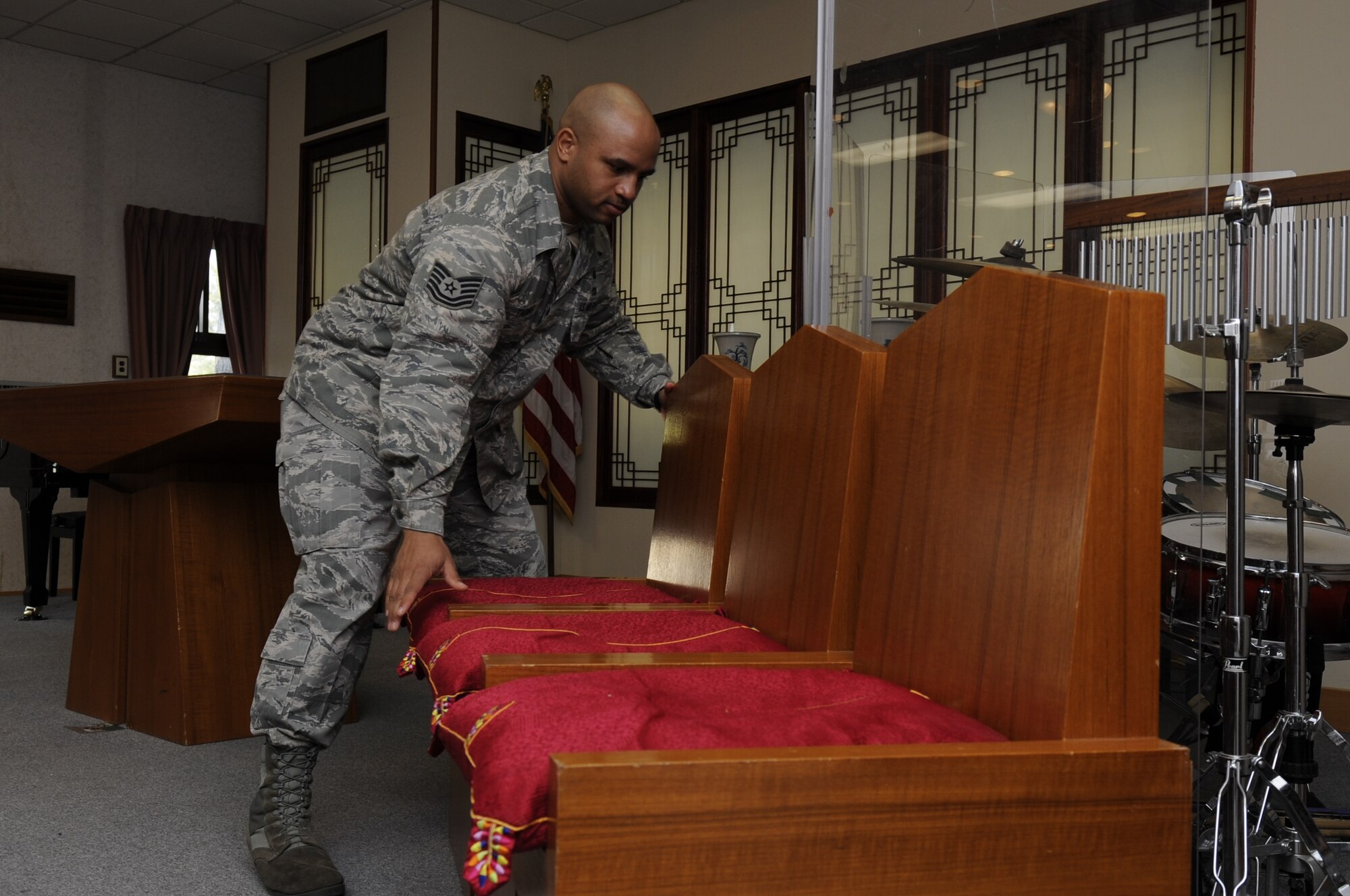 KUNSAN AIR BASE, Republic of Korea -- Tech. Sgt. Andre Thomas, 8th Fighter Wing chapel assistant rearranges chairs back to neutral in the sanctuary at Kunsan Air Base, Republic of Korea, March 14, 2013. The 8th Fighter Wing chapel recently won the Pacific Air Forces 2012 Small Chapel Award. (U.S. Air Force photo by Staff Sgt. Tong Duong.)