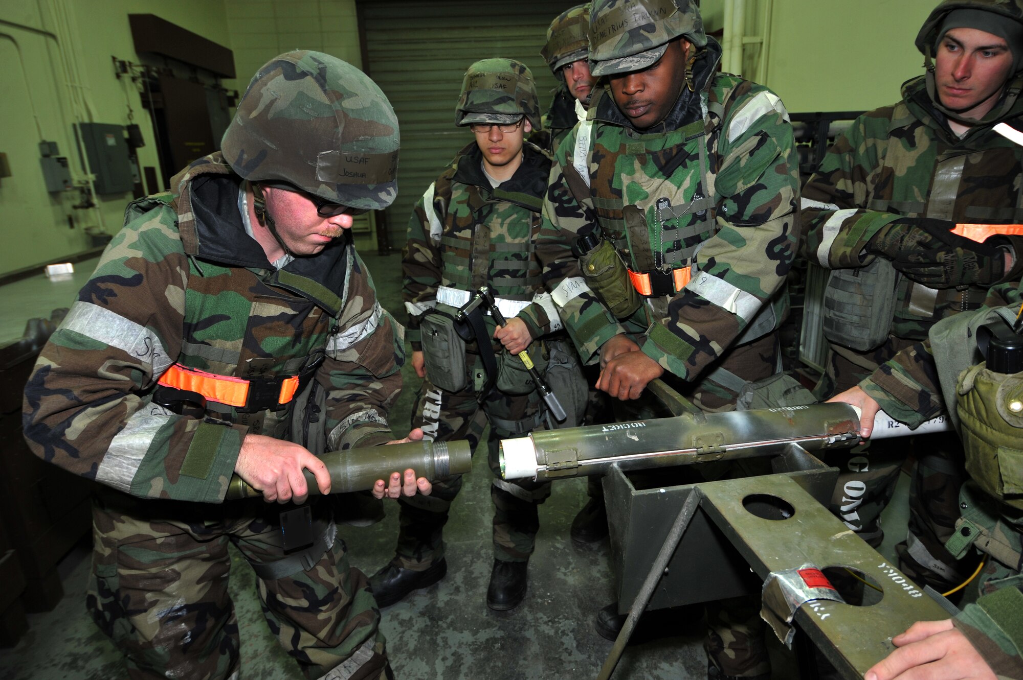 Senior Airman Joshua Guettler, 51st Munitions Squadron conventional maintenance crew member, takes off the war head of a live 2.75-inch-high-explosives rocket for disassembly during Operational Readiness Exercise Beverly Midnight 13-02 at Osan Air Base, Republic of Korea, March 20, 2013.  During Operational Readiness Exercises Beverly Midnight 13-01 and Beverly Bulldog 13-02 2,198 bombs were assembled.  (U.S.  Air Force photo/Staff Sgt. Emerson Nuñez)