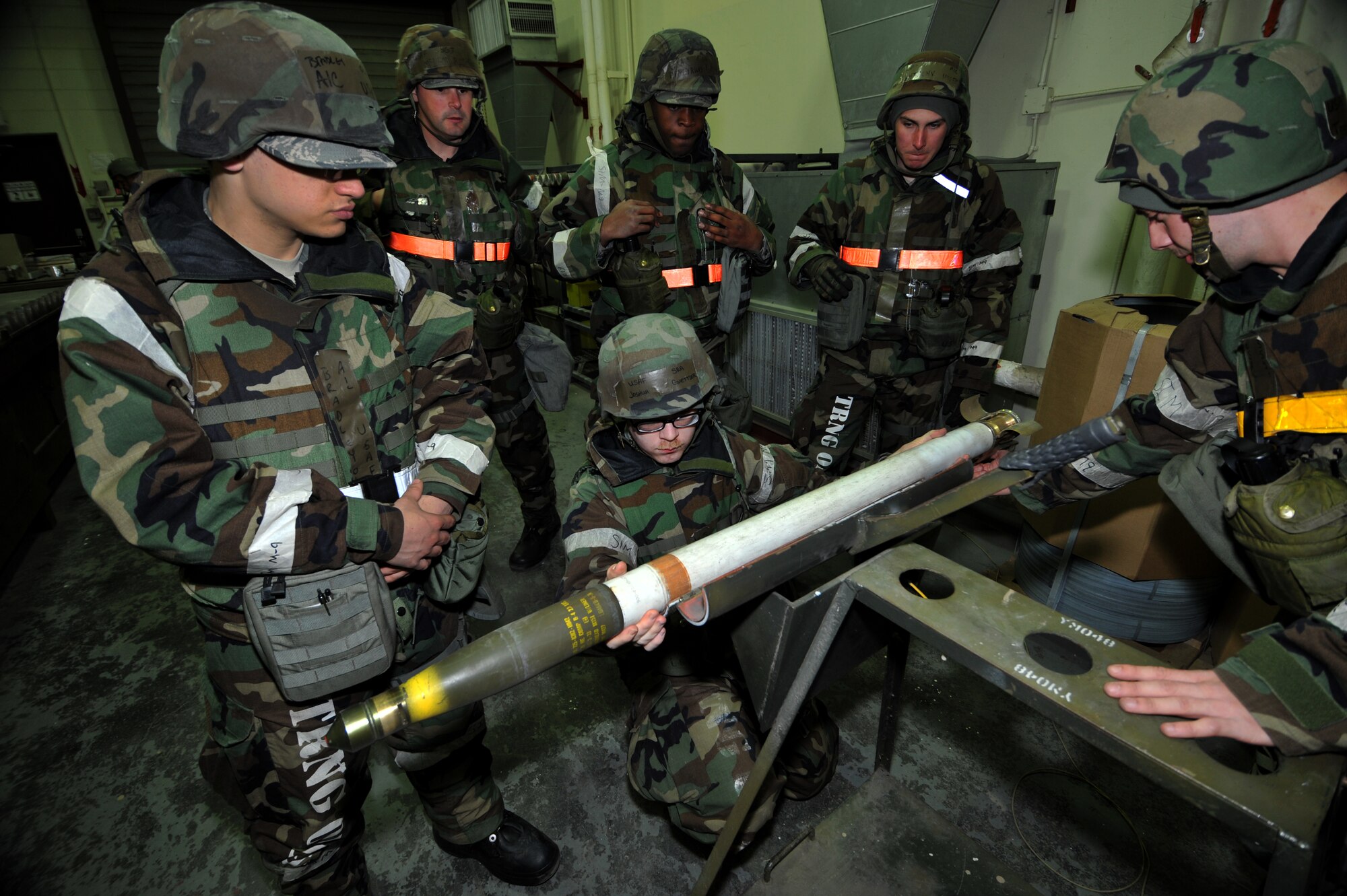 Senior Airman Joshua Guettler, 51st Munitions Squadron conventional maintenance crew member, examines a live 2.75-inch-high explosive rocket for any discrepancies before the rocket is disassembled during Operational Readiness Exercise Beverly Midnight 13-02 at Osan Air Base, Republic of Korea, March 20, 2013.  The aircraft munitions maintenance organization provides lethal combat support through quality munitions.  (U.S. Air Force photo/Staff Sgt. Emerson Nuñez)