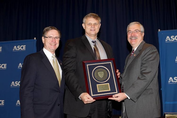Joe Manous (center) receives Government Civil Engineer of the Year award from Pat Natale, Andy Herrmann.