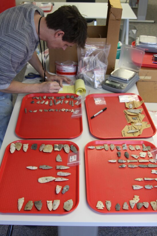 A participant in the U.S. Army Corps of Engineers’ Veterans Curation Program works on preparing artifacts for cataloging. 