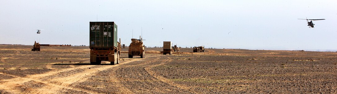 U.S. Marines conduct a combat logistics patrol to Forward Operating Base Geronimo as two helicopters, an AH-1W Super Cobra, right, and UH-1Y Huey, provide overwatch in Afghanistan's Helmand province, March 28, 2013.