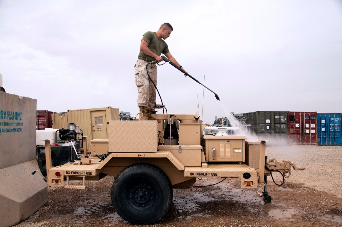 U.S. Marine Corps Lance Cpl. Matthew McKinney washes a portable power unit on Camp Leatherneck in Afghanistan's Helmand province, March 26, 2013. McKinney is assigned to Retrograde and Redeployment in support of the Reset and Reconstitution Operational Group.