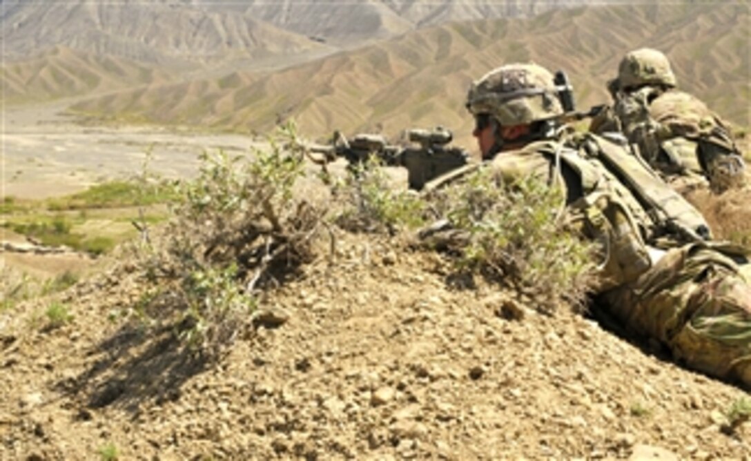 U.S. Army Sgt. David J. Reilly and soldiers with 2nd Battalion, 23rd Infantry Regiment, provide security as Afghan Border Police break ground on a new checkpoint in the Spin Boldak district of Kandahar province, Afghanistan, on March 25, 2013.  The new location allows the police to block an insurgent infiltration route.  