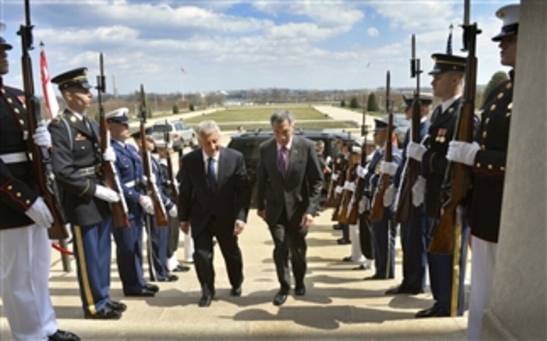 Secretary of Defense Chuck Hagel, left, escorts Singapore’s Prime Minister Lee Hsien Loong through an honor cordon and into the Pentagon on April 1, 2013.  Hagel, Lee and members of their senior staff will meet to discuss national security items of interest to both nations.  
