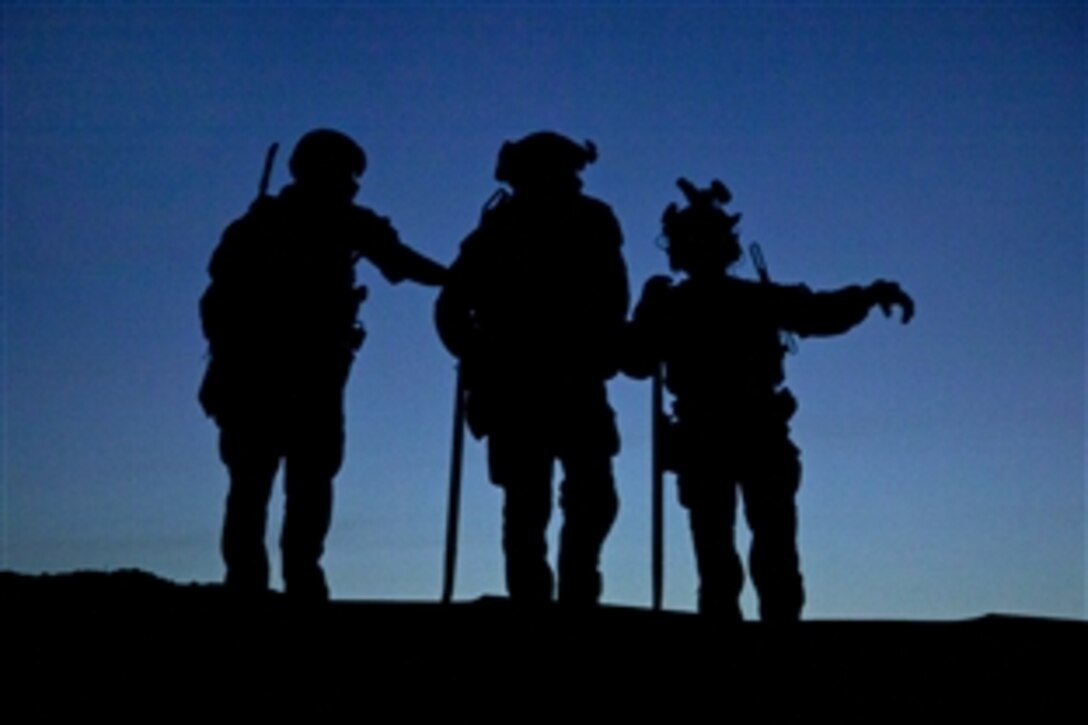 U.S. Marines assigned to a  Special Operations team provide security during a construction project for a new Afghan police checkpoint in Helmand province, Afghanistan, March 30, 2013.