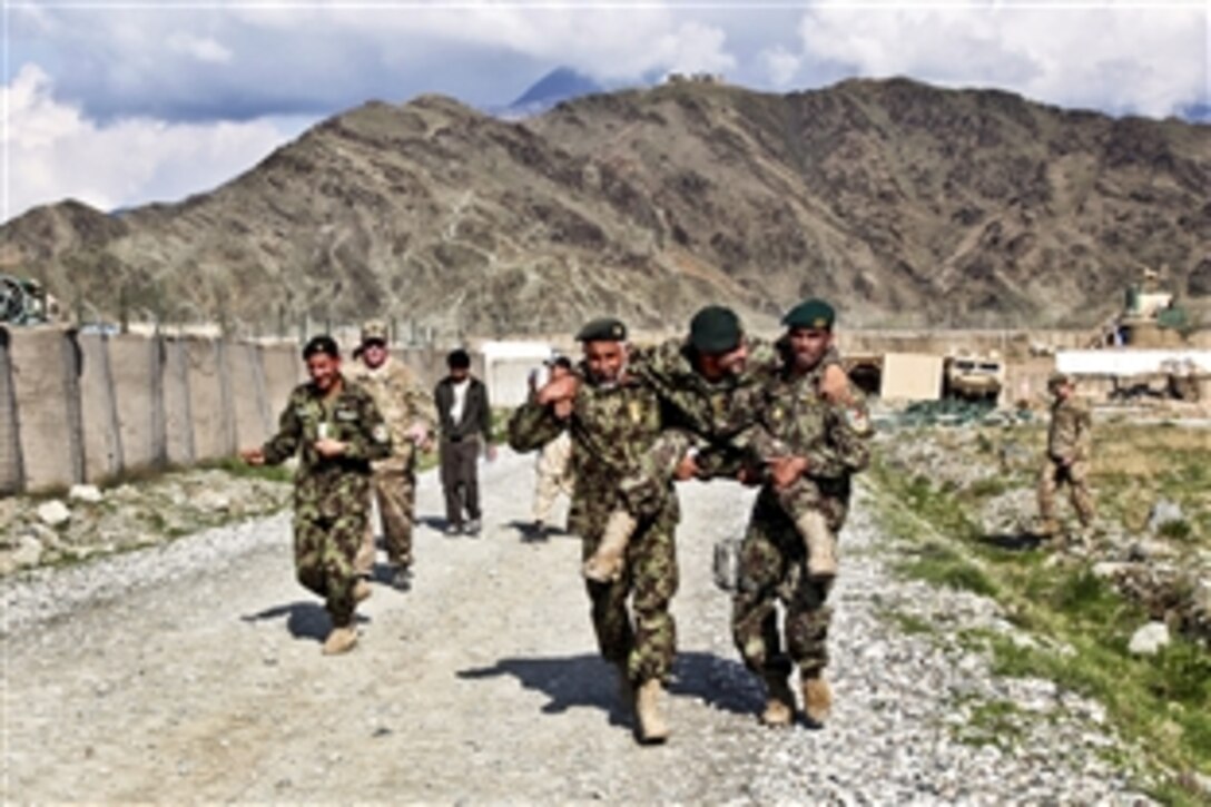 Afghan army soldiers practice the procedure to rescue a patient during medical training on Forward Operating Base Joyce in Afghanistan's Kunar province, March 17, 2013.