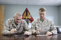 Sgt. Major Robert A. Allen, Marine Corps Air Station New River sergeant major (left) and Lt. Col. Stephen S. Pierson, air station executive officer, fill out their Navy-Marine Corps Relief Society allotment forms at the headquarters building, March 20. 