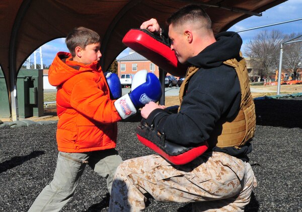 Tyler, 10, gets an opportunity to train March 28, 2013, with Sgt. Mark Green, a martial arts instructor trainer at the Martial Arts Center of Excellence, during a family visit to The Basic School. Medal of Honor recipient 1st Lt. Baldomero Lopez, Tyler’s great uncle, will to have a building on Quantico dedicated to him later this year.