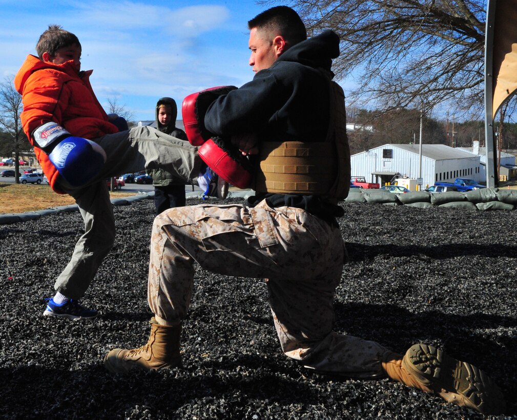 Tyler, 10, gets an opportunity to train March 28, 2013, with Sgt. Mark Green, a martial arts instructor trainer at the Martial Arts Center of Excellence, during a family visit to The Basic School. Medal of Honor recipient 1st Lt. Baldomero Lopez, Tyler’s great uncle, will to have a mess hall on Quantico dedicated to him later this year.
