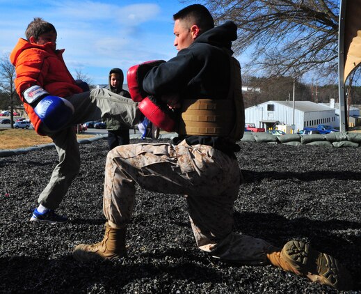 Tyler, 10, gets an opportunity to train March 28, 2013, with Sgt. Mark Green, a martial arts instructor trainer at the Martial Arts Center of Excellence, during a family visit to The Basic School. Medal of Honor recipient 1st Lt. Baldomero Lopez, Tyler’s great uncle, will to have a mess hall on Quantico dedicated to him later this year.