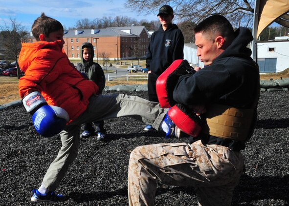 Tyler, 10, gets an opportunity to train March 28, 2013, with Sgt. Mark Green, a martial arts instructor trainer at the Martial Arts Center of Excellence, during a family visit to The Basic School. Medal of Honor recipient 1st Lt. Baldomero Lopez, Tyler’s great uncle, will to have a building on Quantico dedicated to him later this year.