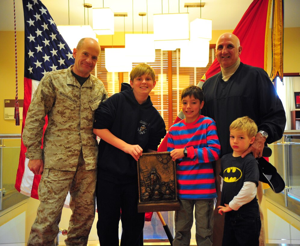 Mike Lopez, right, and his grandchildren, family members of Medal of Honor recipient 1st Lt. Baldomero Lopez, pose with Col. Todd Desgrosseilliers, left, commanding officer of The Basic School, during a visit to TBS March 28, 2013. The honor graduate of each company is presented with The Lopez award, named after the late Korean War hero.