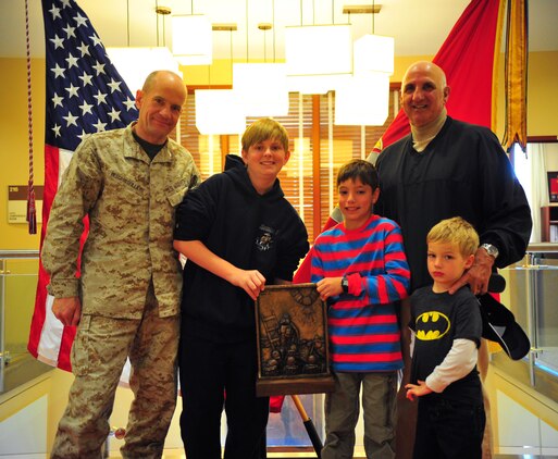 Mike Lopez, right, and his grandchildren, family members of Medal of Honor recipient 1st Lt. Baldomero Lopez, pose with Col. Todd Desgrosseilliers, left, commanding officer of The Basic School, during a visit to TBS March 28, 2013. The honor graduate of each company is presented with The Lopez award, named after the late Korean War hero.