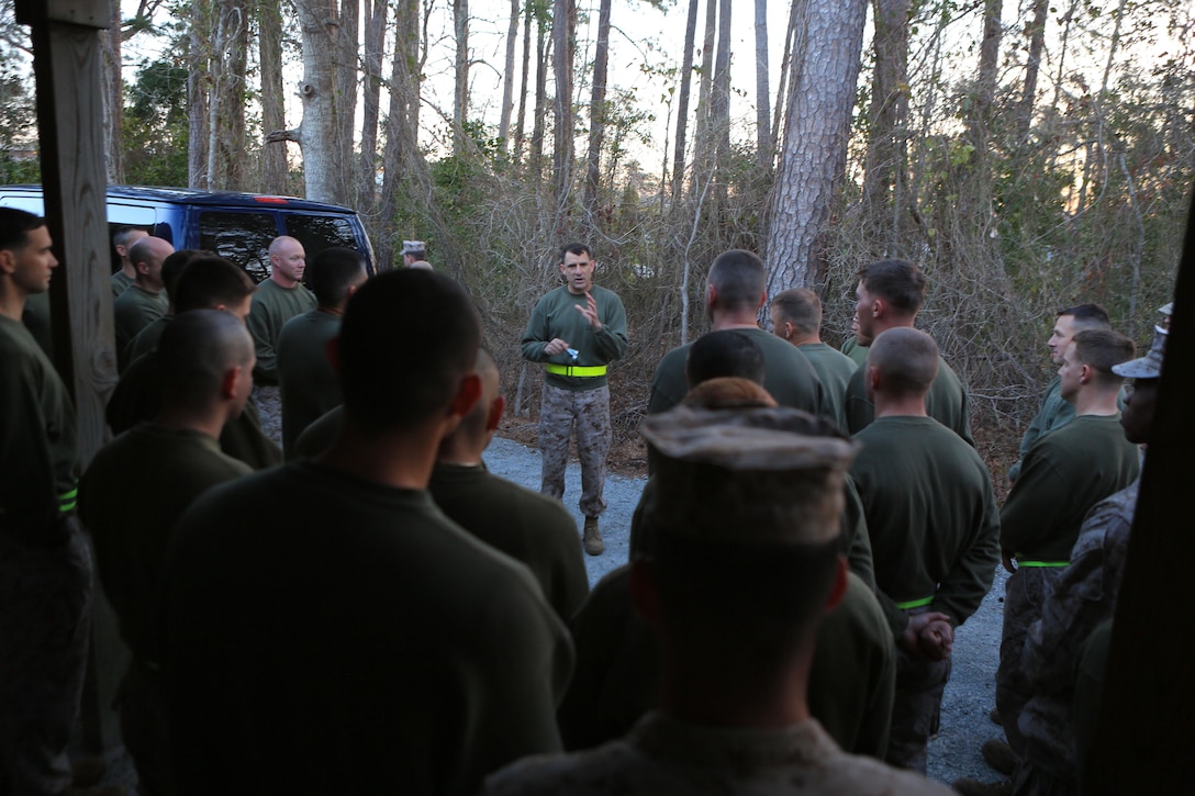 Col. Frank Donovan, the  commanding officer of the 24th Marine Expeditionary Unit, speaks to the unit before the start of a "run, shoot, run" physical training event, March 15, 2013, at Camp Lejeune. During the timed event, four-person groups completed an approximately six-mile run, conducted live-fired of the M9 pistol, and completed a combined total of 120 pull-ups. The 24th MEU returned from a nine-month deployment as an expeditionary crisis response force last December and is preparing for a change-of-command ceremony at the end of the week. (U.S. Marine Corps photo by Sgt. Monique Wallace)