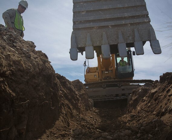 U.S. Marines assigned to Engineer Company, Marine Wing Support Squadron 272, Marine Corps Air Station New River, N.C., use an excavator to dig a trench for a new a culvert designed to protect a newly constructed border security road along the U.S./Mexico border, near Nogales, Ariz., Mar. 19.
