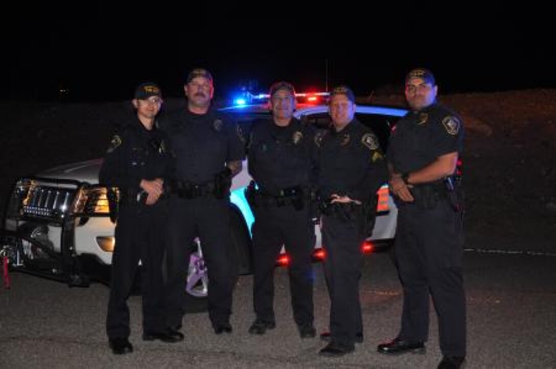 Police officers with Marine Corps Logistics Base Barstow Police Department stand infront of a fully modified emergency response vehicle on base, March 18. The base police department has recently modified the vehicles in their inventory to comply with Marine Corps standards and meet federal and state regulations. The vehicles assist police officers with duties such as patrolling areas, responding to incidents and transporting criminal suspects.
