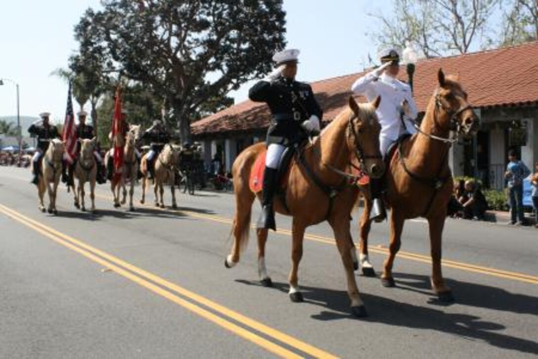Captain Mark P. Lubke, the staff judge advocate for Marine Corps Logistics Base Barstow and Lt. Benjamin Warner, the base chaplain, ride with the Marine Corps Mounted Color Guard during the 55th annual Swallow’s Day Parade in San Juan Capistrano, Calif., March 23.


