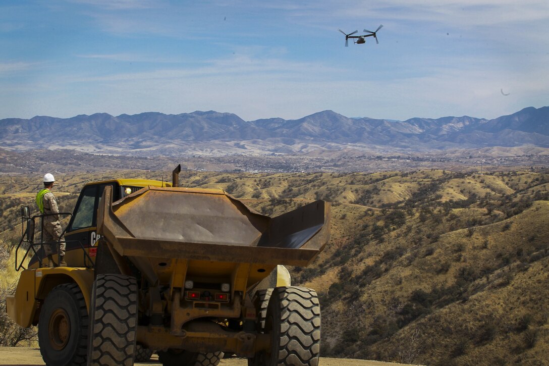 Col. Christopher C. Seymour, Marine Aircraft Group 26 commanding officer and Lt. Col. Patrick R. Hittle, Marine Wing Support Squadron 272 commanding officer, Marine Corps Air Station New River, N.C., conduct a flyover in an MV-22B Osprey to observe their Marines building and improving roads along the U.S./ Mexico border in Arizona, Mar. 19