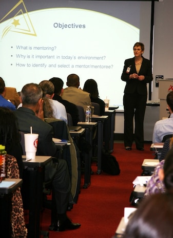 Kathy Wentworth Drahosz, facilitator for the Marine Corps Systems Command mentor program orientation training and president of Training Connection, speaks to participants about the objectives of the program March 28 in Dumfries, Va. 