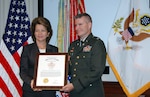 Lt. Col. Joseph Knott receives the Headquarters, Department of the Army Pace Award from Joyce Morrow on July 27 in the Pentagon in Washington, D.C.. Knott is the first National Guard Soldier to win the award in its 45 years. He won the award based on his work in 2006 on the Army Compatible Use Buffer Program.