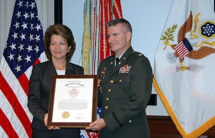 Lt. Col. Joseph Knott receives the Headquarters, Department of the Army Pace Award from Joyce Morrow on July 27 in the Pentagon in Washington, D.C.. Knott is the first National Guard Soldier to win the award in its 45 years. He won the award based on his work in 2006 on the Army Compatible Use Buffer Program.