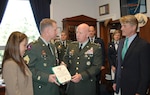 With Mississippi Congressman Gene Taylor (far right) and his wife Mitzi Craig looking on (far left), Sgt. 1st Class John Craig receives the Bronze Star for Meritorious Service from LTG H Steven Blum, chief of the National Guard Bureau, on Aug. 2 at the Rayburn House Office Building in Washington.