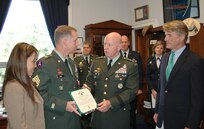 With Mississippi Congressman Gene Taylor (far right) and his wife Mitzi Craig looking on (far left), Sgt. 1st Class John Craig receives the Bronze Star for Meritorious Service from LTG H Steven Blum, chief of the National Guard Bureau, on Aug. 2 at the Rayburn House Office Building in Washington.