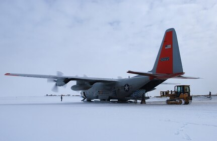 A 109th Airlift Wing LC-130 Hercules is loaded with cargo at Summit Camp on the Greenland Ice Sheet July 24. The wing's gray and orange "skibirds" are the world's largest ski-equipped cargo aircraft.