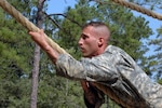 Staff Sgt. Mark Dornbusch of the Texas National Guard tackles the commando crawl obstacle during the 2007 Army National Guard Noncommissioned Officer and Soldier of the Year Competition at the Army National Guard Warrior Training Center at Fort Benning, Ga., on Aug. 3, 2007.