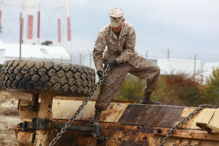 A Marine from 2nd Maintenance Battalion, Combat Logistics Regiment 25, 2nd Marine Logistics Group secures a chain during the Vehicle Recovery Course aboard Camp Lejeune, N.C., March 25, 2013. A mobile training team from Fort Leonard Wood, Mo., traveled to Camp Lejuene to teach the 4 week condensed course. 