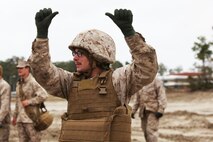 Lance Cpl. Jonathan Baker, a Norfolk, Va., native and motor vehicle operator with 2nd Maintenance Battalion, Combat Logistics Regiment 25, 2nd Marine Logistics Group, gives the signal to begin tightening the cords during the Vehicle Recovery Course aboard Camp Lejeune, N.C., March 25, 2013.  The Marines had to work in teams to bring a Mine Resistant Ambush Protected vehicle back to its original position.