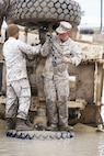 Marines from 2nd Maintenance Battalion, Combat Logistics Regiment 25, 2nd Marine Logistics Group place chains on a Mine Resistant Ambush Protected vehicle during the Vehicle Recovery Course aboard Camp Lejeune, N.C., March 25, 2013.The four week course teaches Marines how to recover vehicles using crane operations, retrieval systems and a lift tow. 