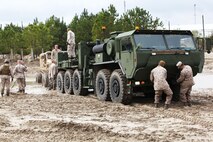 Marines from 2nd Maintenance Battalion, Combat Logistics Regiment 25, 2nd Marine Logistics Group attach a Logistics Vehicle System Replacement to pull out a Mine Resistant Ambush Protected vehicle during the Vehicle Recovery Course aboard Camp Lejeune, N.C., March 25, 2013.  A Marine Corps instructor came down from Fort Leonard Wood, Mo., teaching the Marines about vehicle recovery operations.