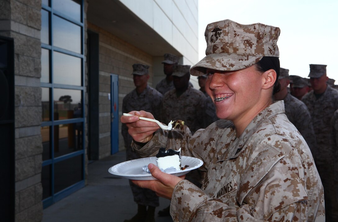 Lance Cpl. Melissa Johnson, Marine of the Quarter with Marine Aerial Refueler Transport Squadron 352 and a New Market, Tenn., native, prepares to bite into the first piece of cake during the squadron's 70th birthday celebration aboard Marine Corps Air Station Miramar, Calif., March 28. During the celebration, the squadron's commanding officer recognized Johnson for having gone the extra mile, both as a Marine and member of the community by volunteering and pursuing higher education.