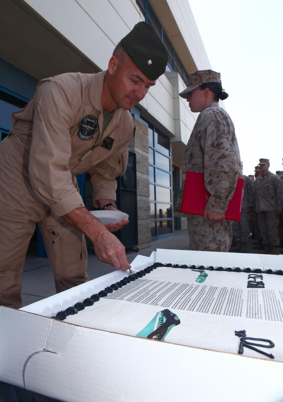 Lt. Col. Jason Kindred, left, commanding officer of Marine Aerial Refueler Transport Squadron 352 and a Spokane, Wash., native, cuts a slice of cake for Lance Cpl. Melissa Johnson, right, Marine of the Quarter with VMGR-352and a New Market, Tenn., native, during the squadron's 70th birthday aboard Marine Corps Air Station Miramar, Calif., March 28. During the celebration, Kindred gave a brief description on how far the squadron has come since its creation 70 years ago, and expressed his appreciation for the hard-working Marines of his squadron.