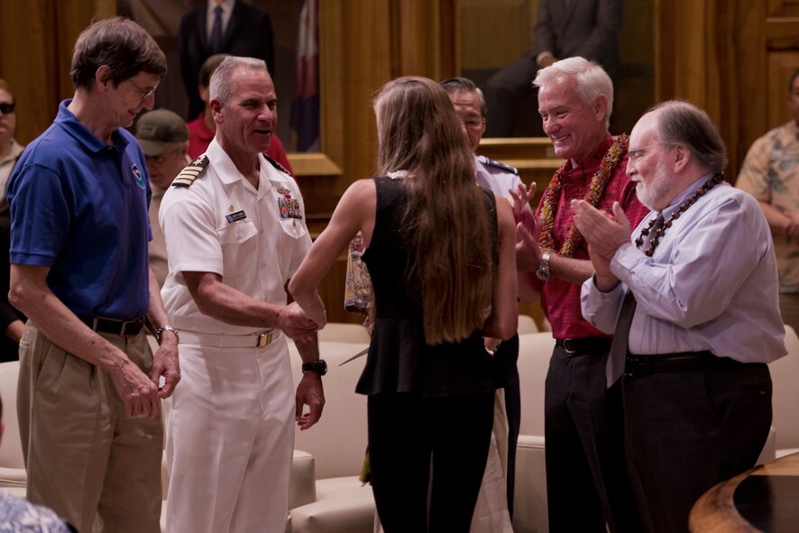 Gerald Fryer, senior geophysics at NOAA's Pacific Tsunami Warning Center, and  U.S. Navy Capt. Jeff James, Joint Base Pearl Harbor-Hickam commander, hand out prizes to the winners of the Tsunami Awareness Month poster contest at the state capitol building  April 1, 2013. Hawaii Gov. Neil Abercrombie proclaims April as Tsunami Awareness Month at the state capitol building  April 1, 2013. The Hawaii State Civil Defense, the mayor of the city and county of Honolulu, Department of Emergency Management and National Oceanographic and Atmospheric Administration's National Weather Service and representatives from the Department of Defense all took part in the proclamation which emphasizes the importance of tsunami awareness and preparedness for residents and visitors of Hawaii. (U.S. Air Force photo/Staff Sgt. Mike Meares)