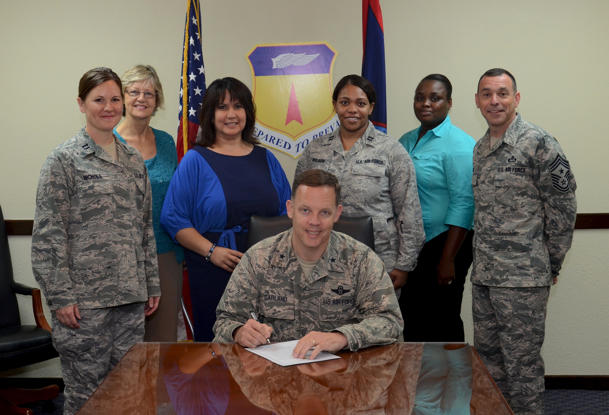 Brig. Gen. Steven Garland signs a proclamation for April’s Child Abuse Prevention Month on Andersen Air Force Base, Guam, April 1, 2013. Throughout the month, there are programs and activities scheduled on Andersen AFB that focus on the positive message of supporting children, families and strengthening communities to prevent incidents of child abuse. (U.S. Air Force photo by Senior Airman Benjamin Wiseman/Released)