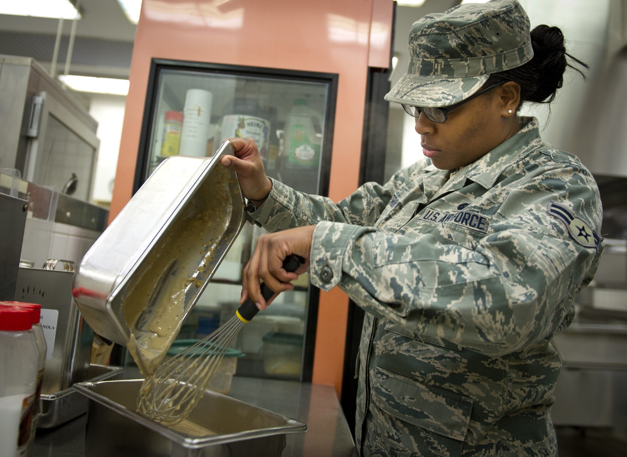 YOKOTA AIR BASE, Japan -- Airman 1st Class Rachel Armstrong, 374th Force Support Squadron food service apprentice, prepares gravy for dinner time at the Samurai Café Dining Facility, Yokota Air Base, Japan, March 27, 2013. The Samurai Café is manned 24-hours a day, seven days a week, 365 days a year, and provides quality food for Yokota's Airmen. (U.S. Air Force photo by Senior Airman Andrea Salazar)