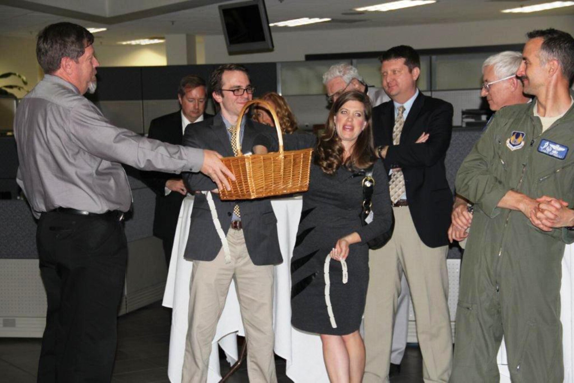 Christine Scrivner, wife of Kern County Supervisor Zach Scrivner (dark sport coat and tan slacks), is drawing the winning ticket for the 50/50 drawing during annual Edwards Civilian Military Support Group Spring Mixer in Bldg. 3000. A total of $440 raised in the drawing and Michelle Slade won and then donated the $220 in winnings to the Airman's Attic. (Courtesy photo)