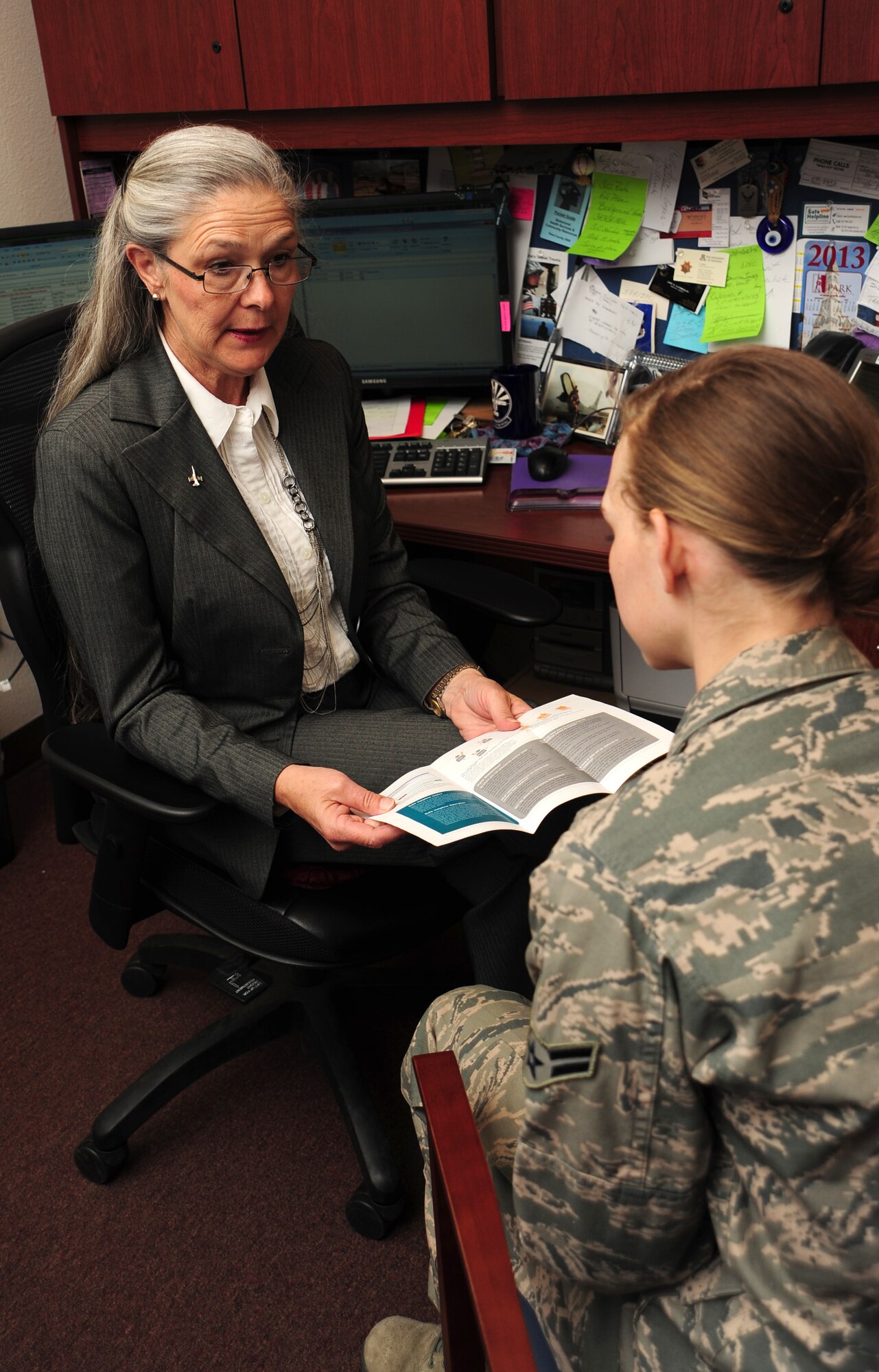 Vickie Jo Ryder, 355thFighter Wing sexual assault response coordinator, educates a U.S. Air Force Airman about Sexual Assault Awareness Month at Davis-Monthan Air Force Base, Ariz., April 2, 2013. The Desert Lightning Team is hosting several events in support of SAAM. (U.S. Air Force photo by Senior Airman Camilla Griffin/ Released) 