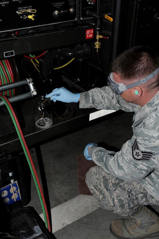 Staff Sgt. Dallas English, 28th Logistics Readiness Squadron fuels laboratory NCO in charge, collects jet fuel during a monthly sample test at Ellsworth Air Force Base, S.D., March 26, 2013. Monthly sample tests verify fuel quality in order to safeguard B-1 engines against contamination and damage. (U.S. Air Force photo by Airman 1st Class Anania Tekurio/Released)
