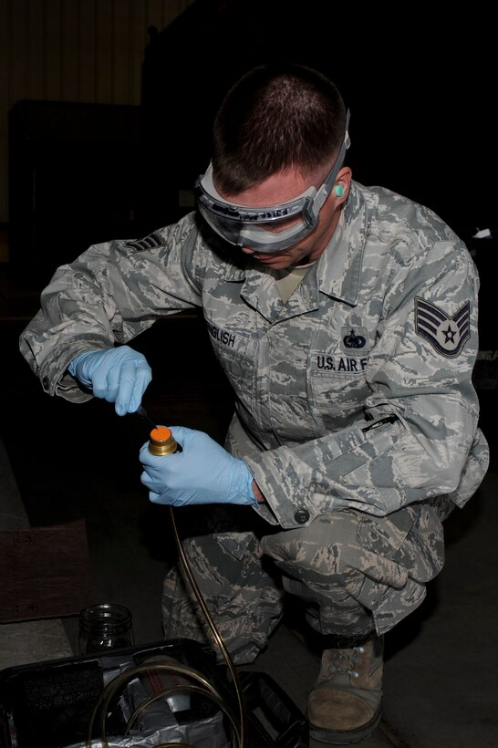 Staff Sgt. Dallas English, 28th Logistics Readiness Sqaudron fuels laboratory NCO in charge, places a water detection pad on a hose during a monthly fuel sample test on a fuel truck at Ellsworth Air Force Base, S.D., March 26, 2013. The pad absorbs samplings of the jet fuel while keeping out water and other contaminants that could damage B-1 fuel filters and sensing lines. (U.S. Air Force photo by Airman 1st Class Anania Tekurio/Released)