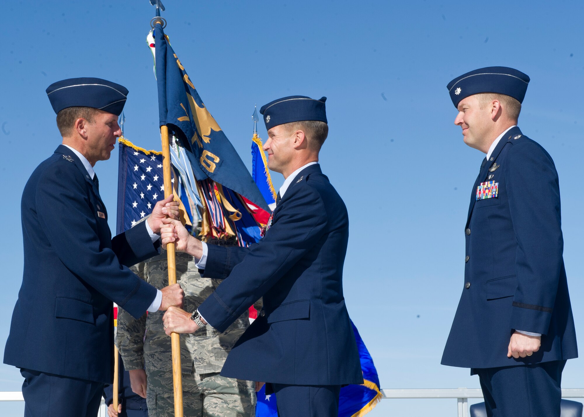 Lt. Col. Larry Broadwell, 7th Fighter Squadron outgoing commander, relinquishes command of the 7th FS to Col. Kenneth Johnson, 49th Operations Group commander, during the change of command ceremony at Holloman Air Force, N.M., April 1. Broadwell’s next assignment will be as the executive officer to the Air Combat Command commander. (U.S. Air Force photo by Senior Airman DeAndre Curtiss/Released) 