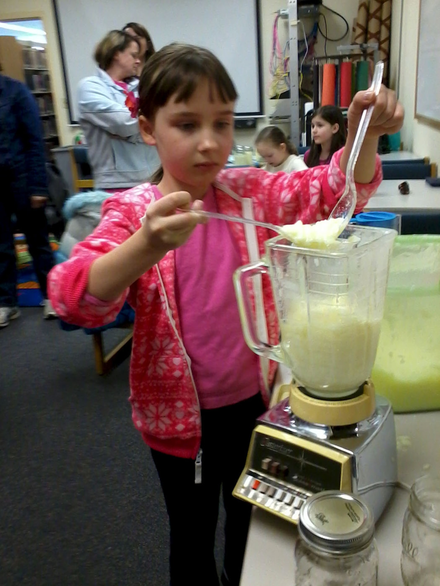 Beth Hebling, 9, adds another clump of melted laundry soap to a blender during a do-it-yourself event hosted March 29, 2013, at the Grand Forks Air Force Base Library. (U.S. Air Force photo/Staff Sgt. Luis Loza Gutierrez)