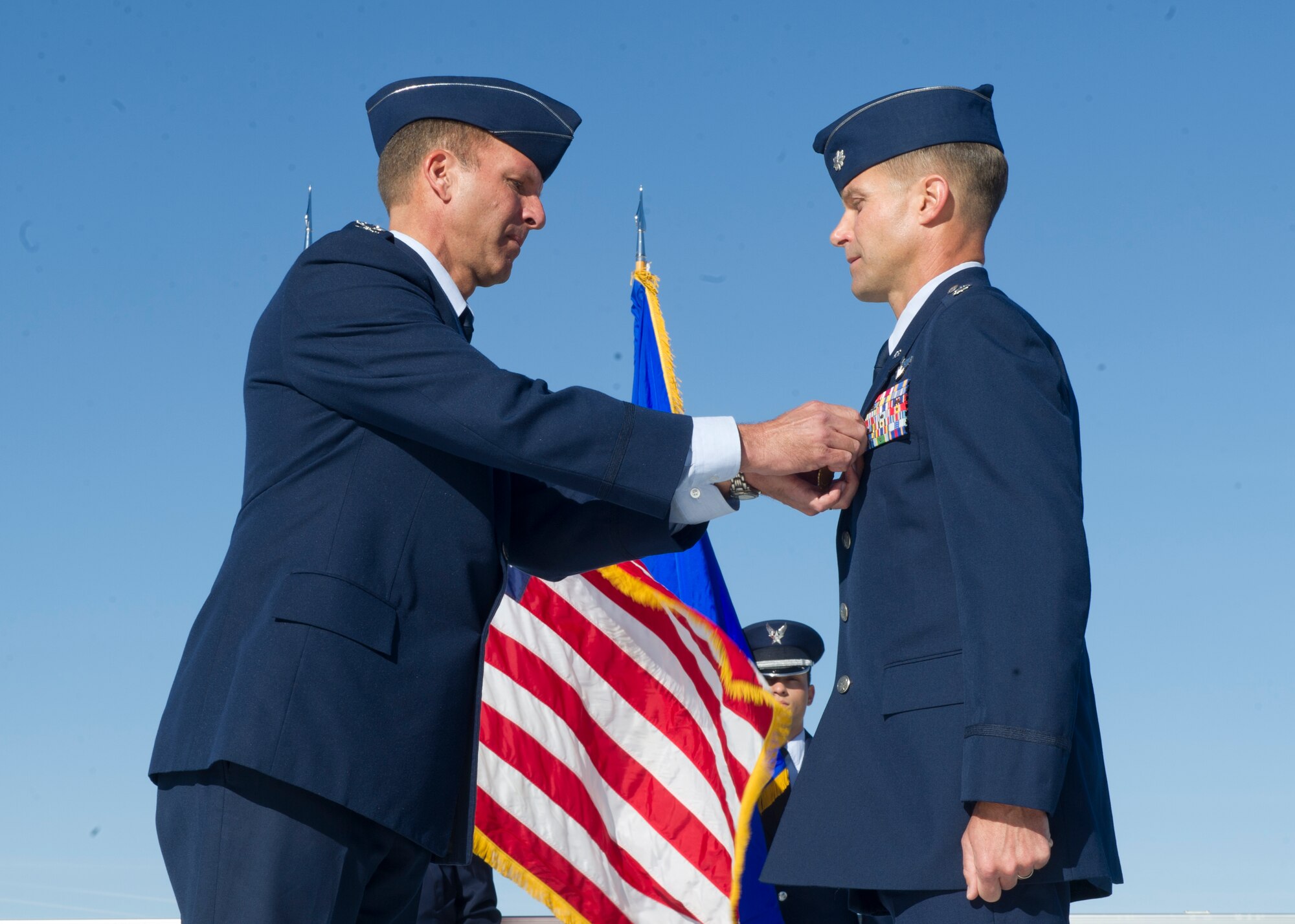 Colonel Kenneth Johnson, 49th Operations Group commander, presents Lt. Col. Larry Broadwell with the Meritorious Service Medal during the 7th Fighter Squadron change of command, April 1. Johnson was the presiding officer for the ceremony that saw Broadwell relinquish command of the 7th FS to Lt. Col. Shawn Anger. Broadwell was presented the MSM for his outstanding leadership of the 7th FS since assuming command October 2011. (U.S. Air Force photo by Senior Airman DeAndre Curtiss/Released) 